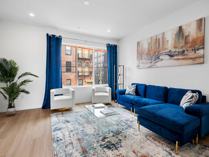 a living room with blue couches